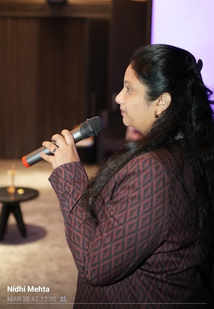 Nidhi Parikh speaking at a gathering